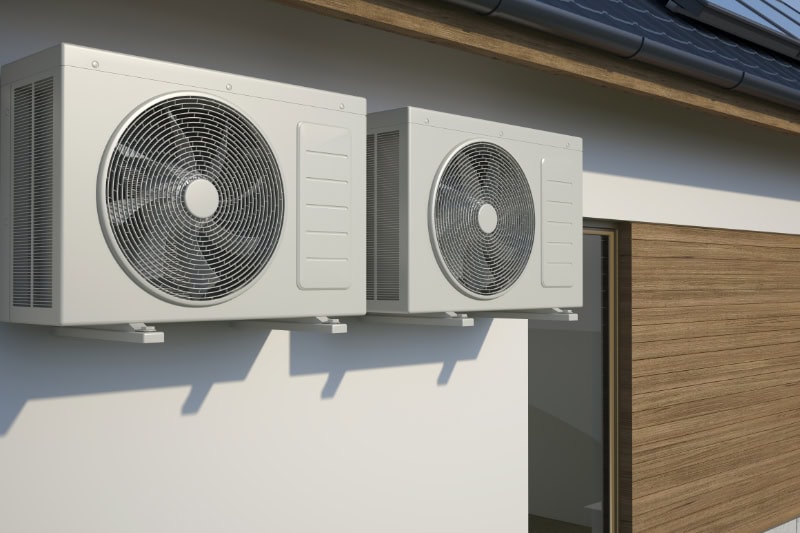 air conditioners attached to the side of the building.